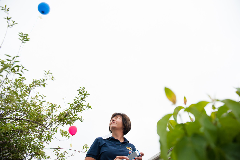 Principal Robin Calcutt watches balloons float away after students released them at West Pine Middle School for a garden dedication ceremony in honor of Mindi Zumwalt who recently lost her fight with cancer, on Friday, June 5, 2015 in Pinehurst, North Carolina.