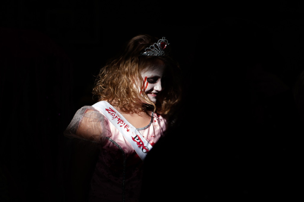 Zoey Upchurch walks through a band of light streaming through the gymnasium windows while dressed as a Zombie Prom Queen during the Halloween Costume parade in the gymnasium of High Falls Elementary School on Friday, October 30, 2015 in Robbins, North Carolina.